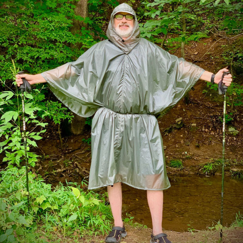 A front view of the MLD Pro Poncho in Poncho Mode on a an ultralight hiker.