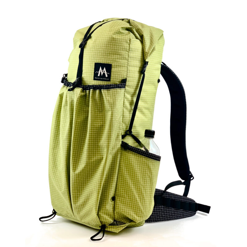 A 3/4 side view of the MLD Burn 38L backpack in Wasabi Green
