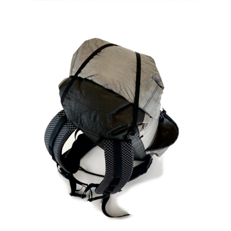 A top down shot of the MLD Burn 38L in Ultra 200/400 showing the roll down top, top compression strap and top of the shoulder straps.