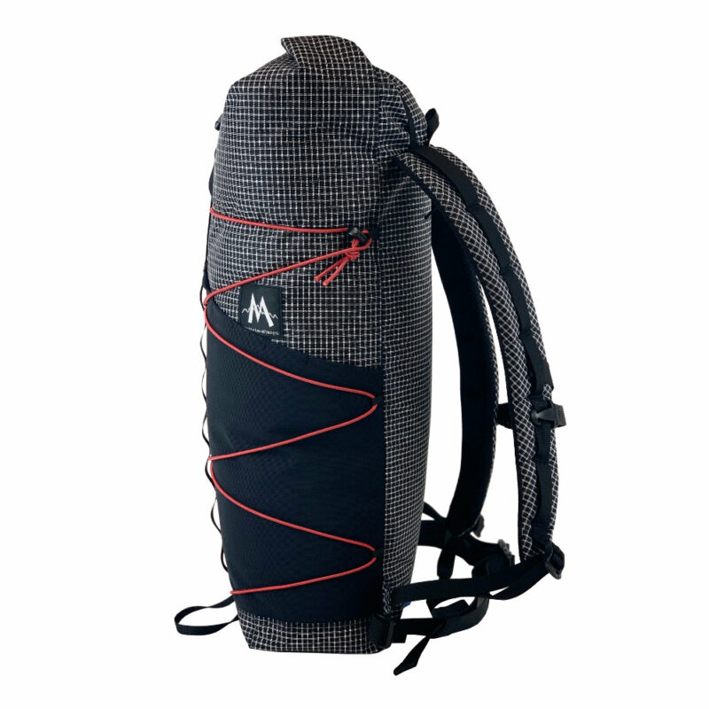 A left side view of the MLD Hell 27L in Blasck Beauty UltraGrid with red bungee cord