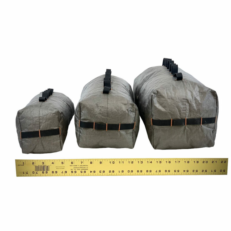 A bottom view of the Ultra 200 X Bike Dry Bags showing the sizes 7L, 12L, and 22L. The measuring tape shows they are approx. 5" wide, 6" wide, and 7" wide. Please see product description for actual dimesions.