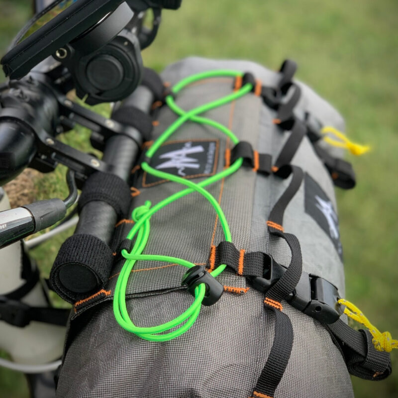 Top side view of Border Handlebar Harness System mounted on a bike and holding an Ultra X Double End Handlebar Dry Bags