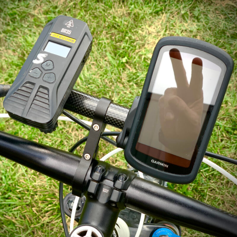 The Auxiliary Nav and Light Bar Mounted on a Bike with a reflection of a peace sign in the GPS screen.