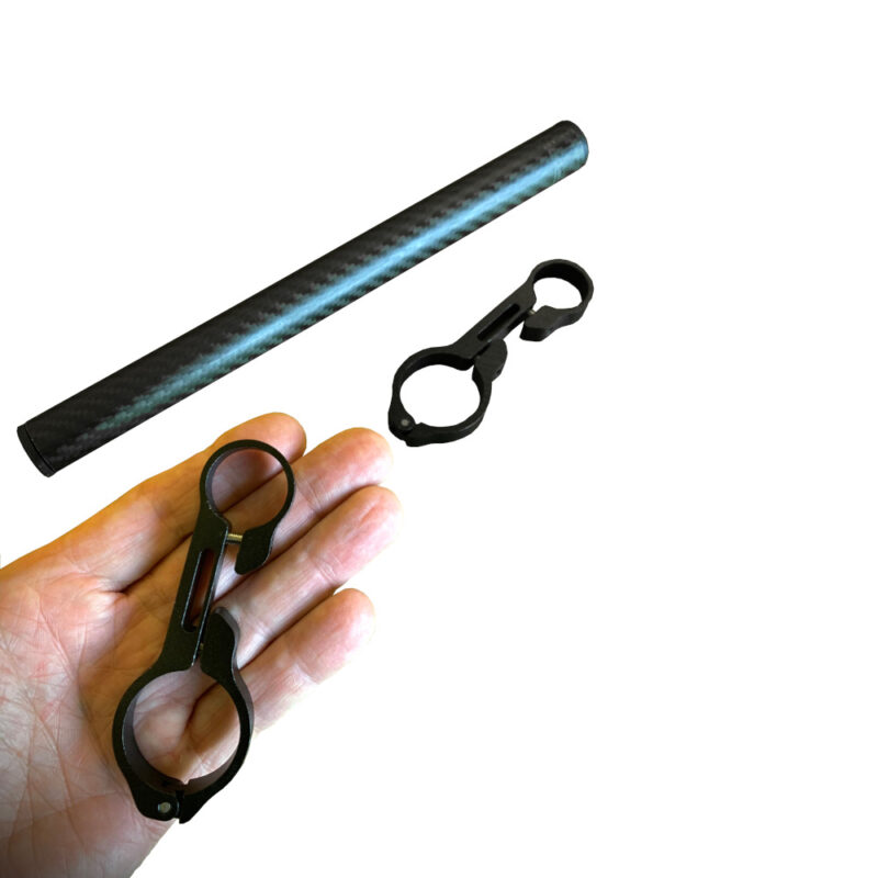 A CF tube and two Border Bar Clamps, with a hand holding one of them